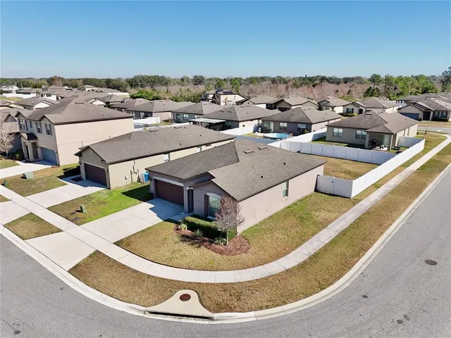 an aerial view of a house with a yard