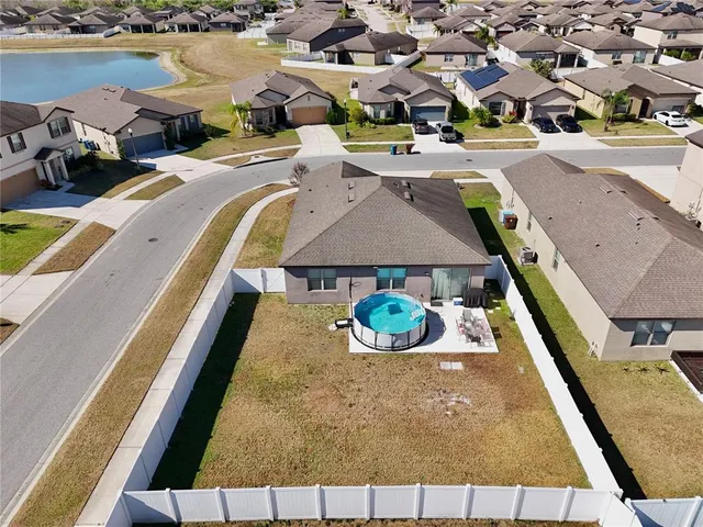 an aerial view of a swimming pool with seating area