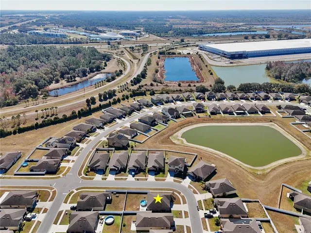 an aerial view of a building with garden space and outdoor seating