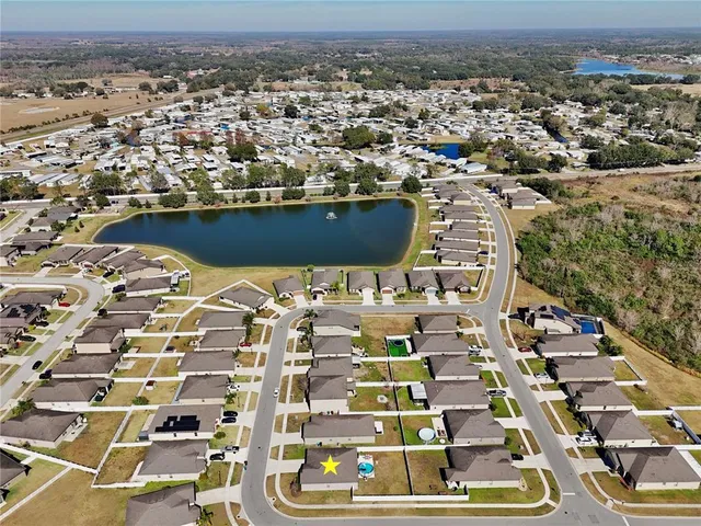 an aerial view of residential houses with yard