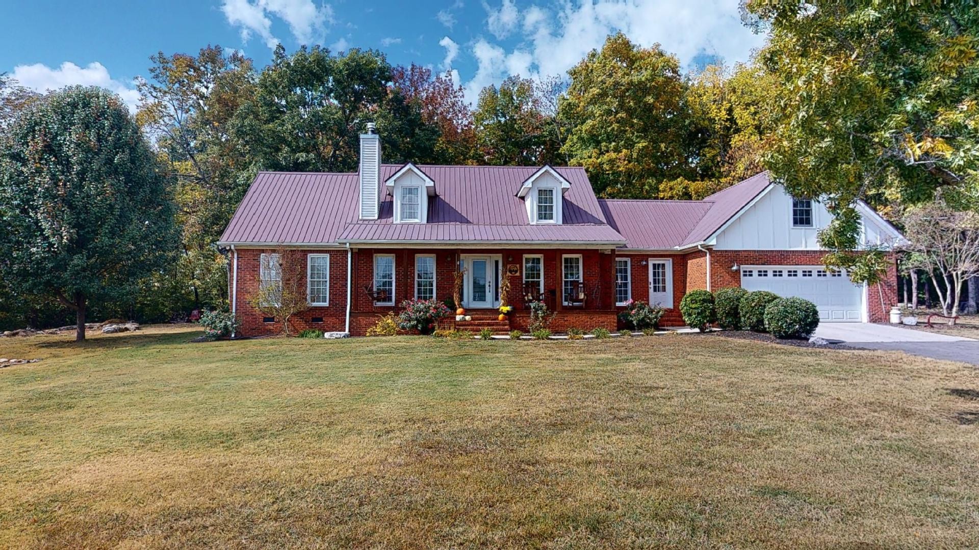 a front view of a house with yard porch and furniture