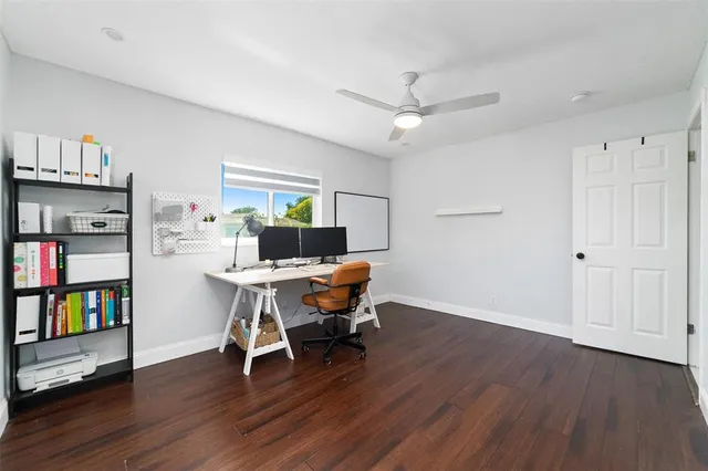 a workspace with wooden floor and a book shelf