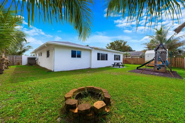 a front view of house with yard and entertaining space