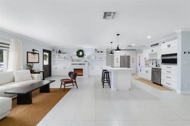 a living room with fireplace furniture and a flat screen tv
