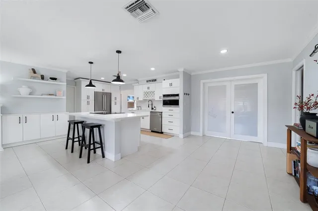 a view of kitchen with furniture and refrigerator