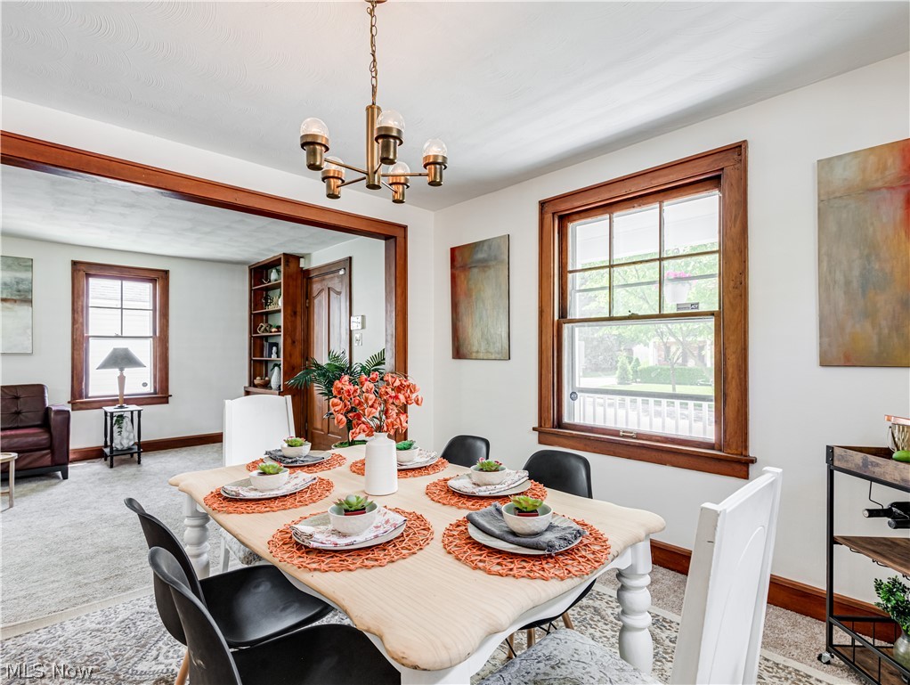 377 East Wilbeth Road Akron, OH 44301 - Photo 7 of 25 Carpeted dining area featuring a wealth of natural light and a notable chandelier