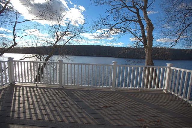 a view of deck with wooden floor and fence with wooden fence