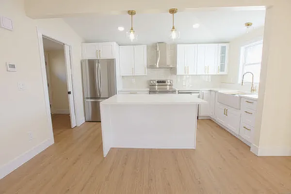 a kitchen with stainless steel appliances a refrigerator sink and cabinets