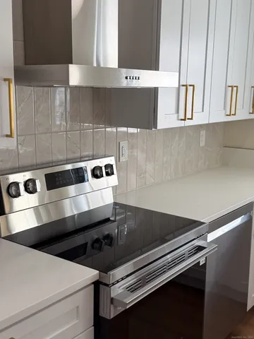 a close view of stove and cabinets