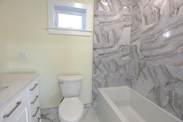 a bathroom with a toilet and a bathtub