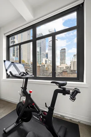 a living room with furniture a flat screen tv and a large window