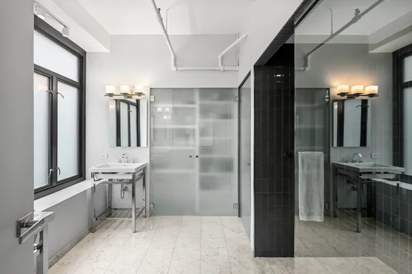 a spacious bedroom with a large bed and a large window