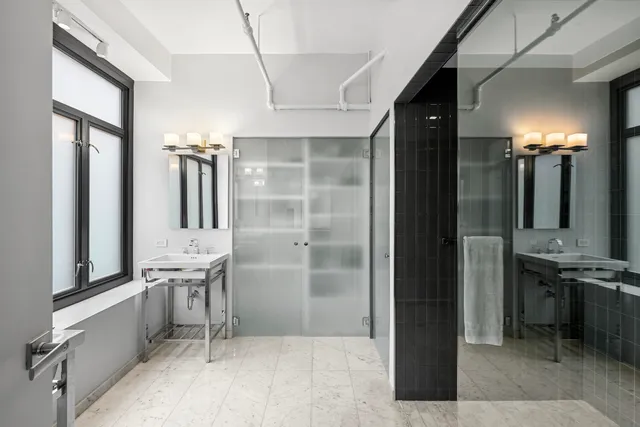 a spacious bedroom with a large bed and a large window