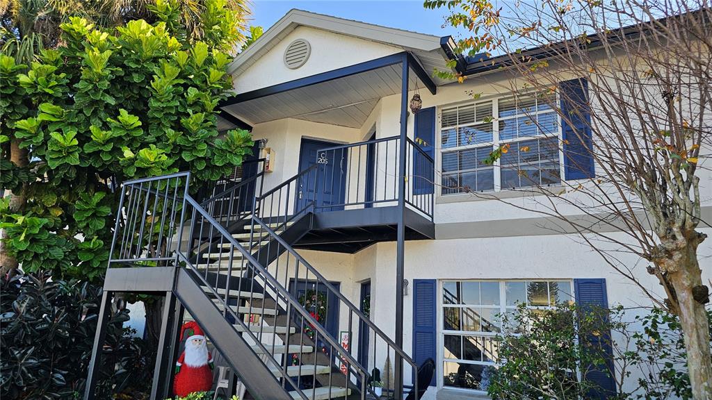 a front view of a house with a tree