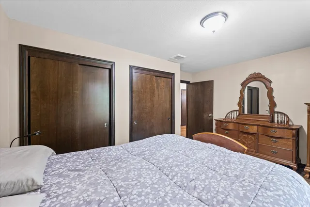 a bedroom with a bed and a dresser