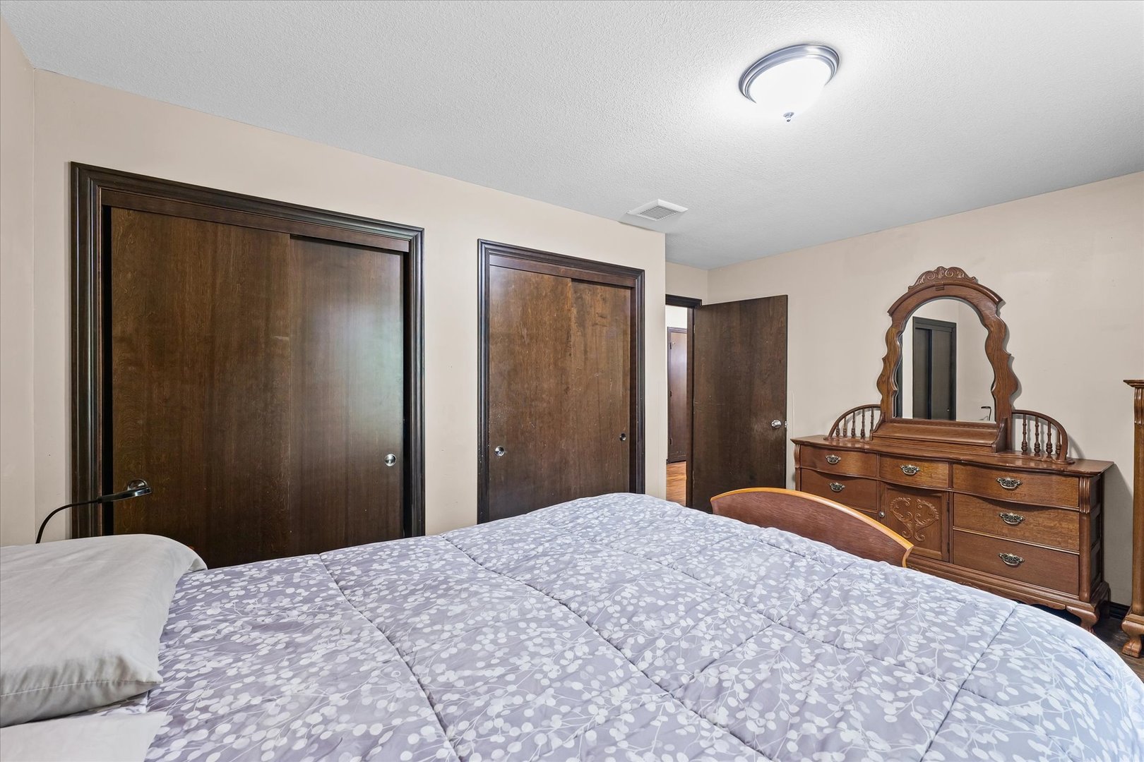601 Curtis Road Ogden, IL 61859 - Photo 18 of 29 a bedroom with a bed and a dresser