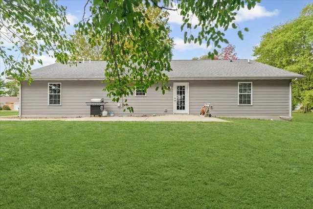 a view of a house with a backyard