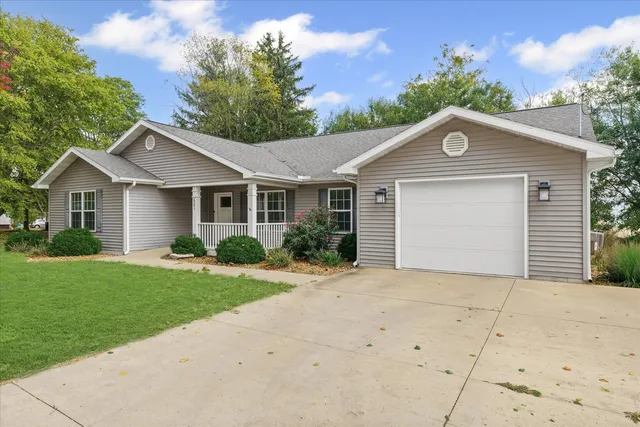 a front view of a house with a garden and yard