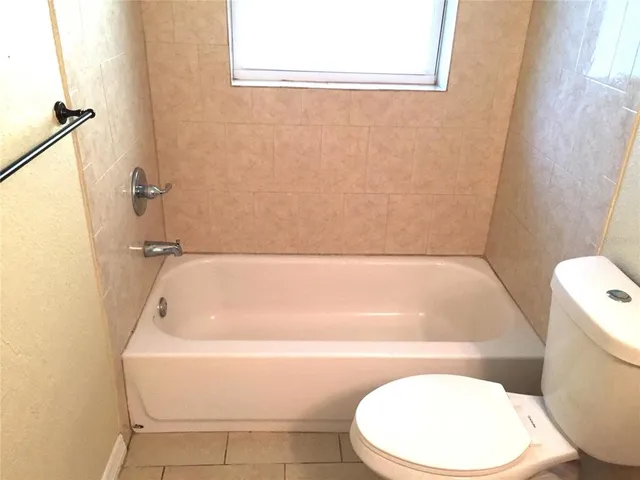 a bathroom with a toilet and bathtub