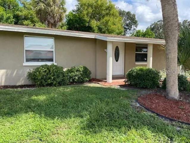 a view of a house with a yard and plants