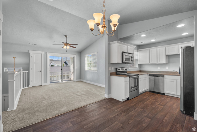 2457 West 500 South, Unit 2 Springville, UT 84663 - Photo 11 of 27 Open-concept kitchen and living area featuring white cabinetry, stainless steel appliances, and wood-finish flooring