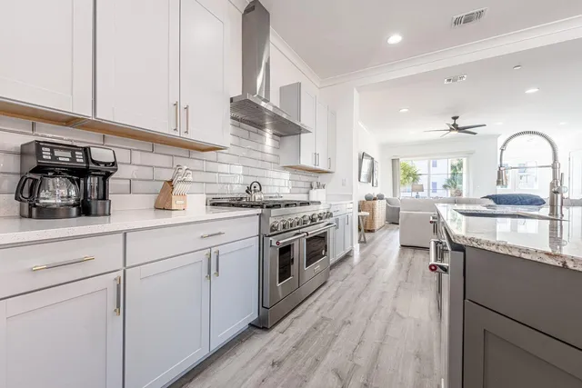 a view of a dining room with furniture large windows and wooden floor