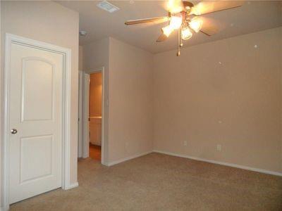 5321 Locust Drive McKinney, TX 75070 - Photo 11 of 17 en empty room with windows and chandelier fan