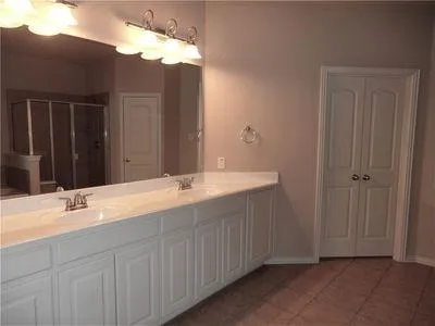 a bathroom with a double vanity sink and a mirror