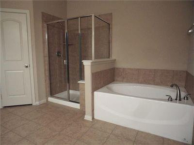 5321 Locust Drive McKinney, TX 75070 - Photo 13 of 17 a bathroom with a bathtub and a shower