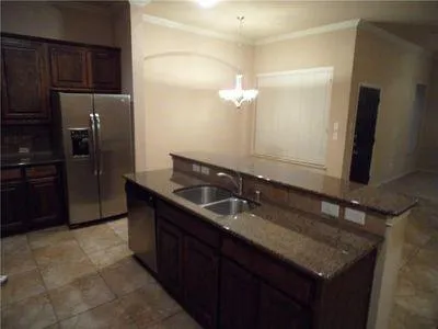 a bathroom with a granite countertop sink a mirror and a shower