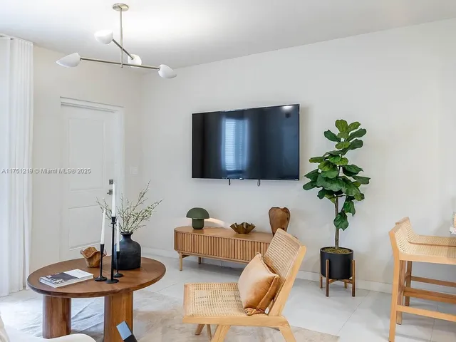 a living room with furniture and a potted plant