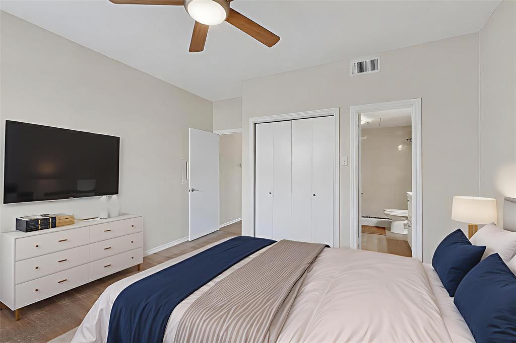 14277 Preston Road, Unit 923 Dallas, TX 75254 - Photo 21 of 39 a bedroom with a bed and a flat screen television