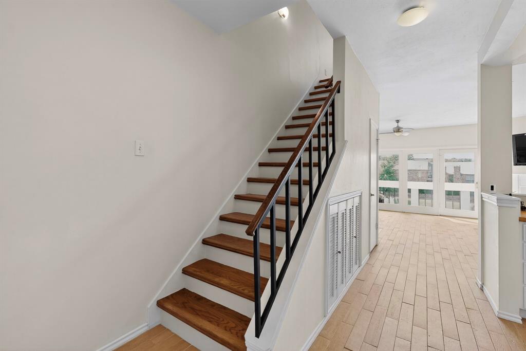 14277 Preston Road, Unit 923 Dallas, TX 75254 - Photo 25 of 39 a view of staircase with wooden floor and white walls