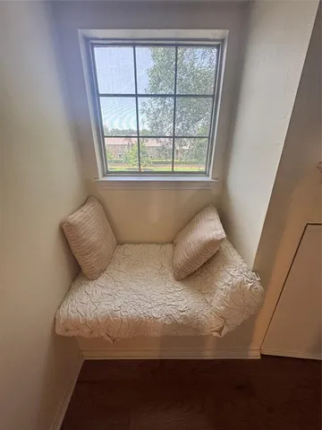a bed sitting in a bedroom next to a window