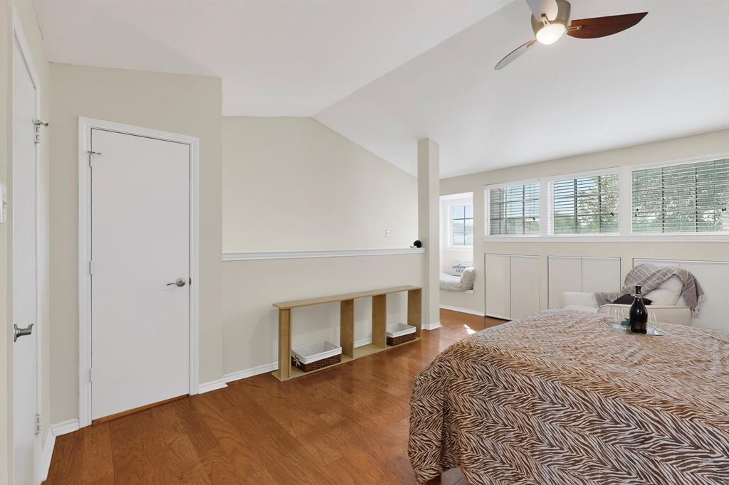 14277 Preston Road, Unit 923 Dallas, TX 75254 - Photo 30 of 39 a bedroom with a bed and wooden floor