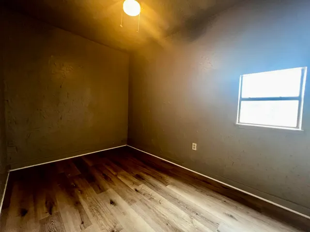 a view of a room with wooden floor