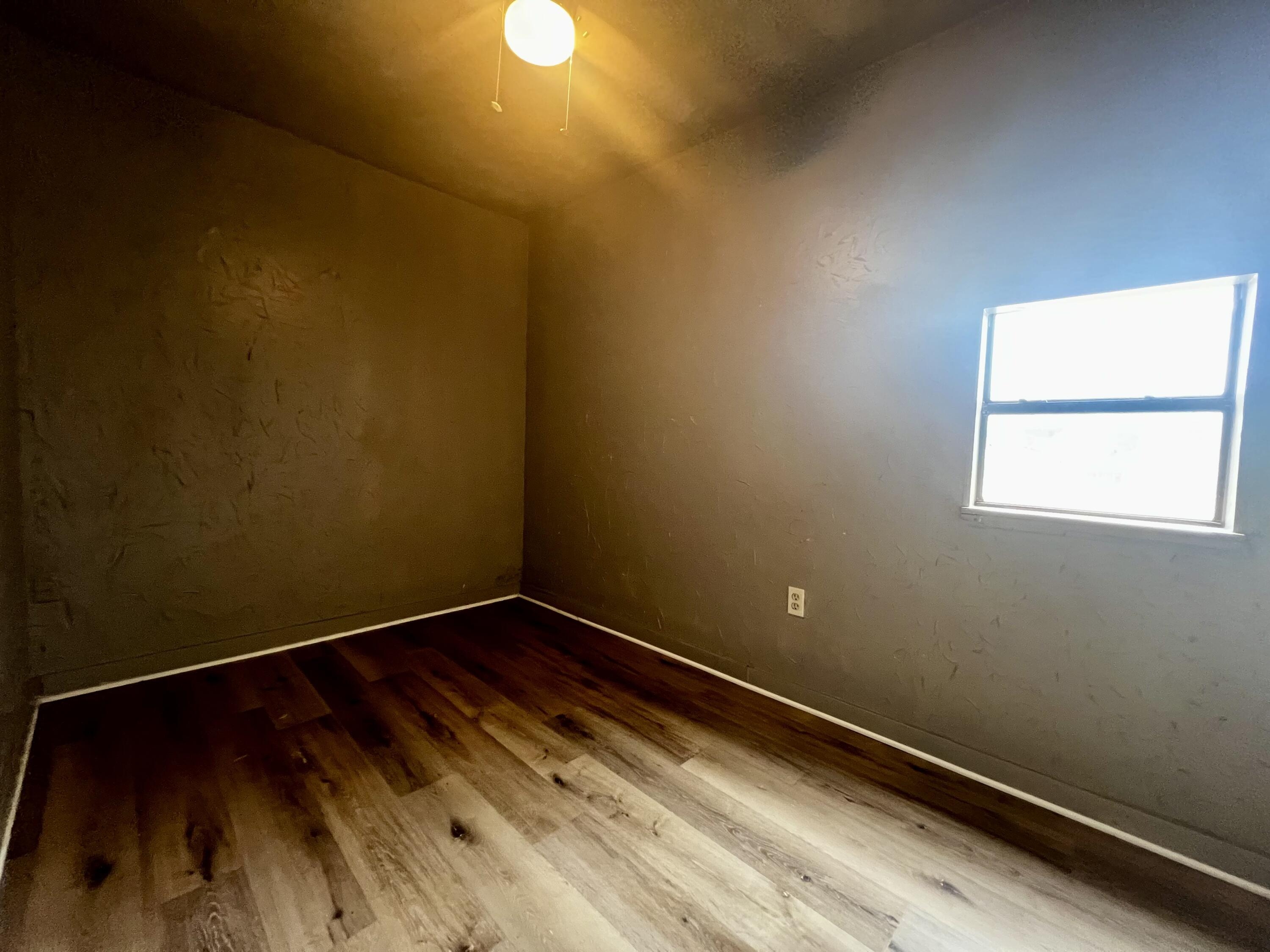 220 North 6th Street Slaton, TX 79364 - Photo 7 of 8 a view of a room with wooden floor