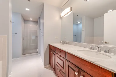 a bathroom with a granite countertop sink mirror and double