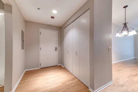 a view of empty room with wooden floor