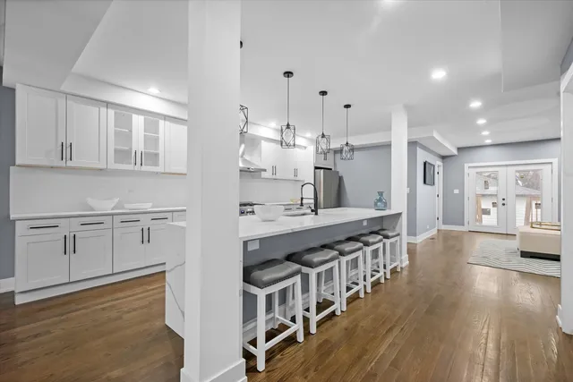 a kitchen with stainless steel appliances granite countertop a stove and cabinets