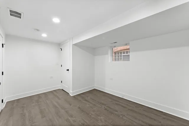 a view of a room with wooden floor and window