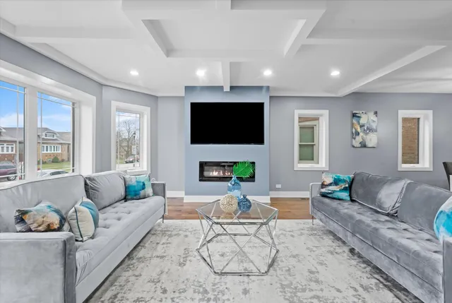 a living room with furniture a fireplace and a flat screen tv