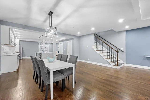 a view of a dining room with furniture wooden floor and chandelier