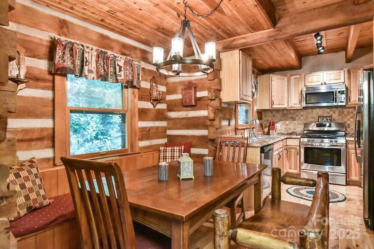48 Buck Ridge Road Fairview, NC 28730 - Photo 11 of 38 a view of a dining room with furniture window and outside view