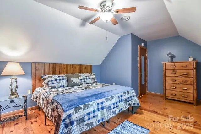 a bedroom with a bed a rug and a chandelier