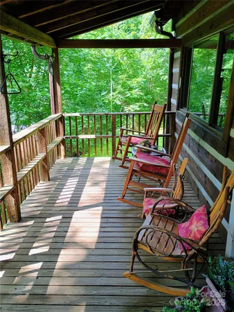 a view of a deck with wooden floor and outdoor seating