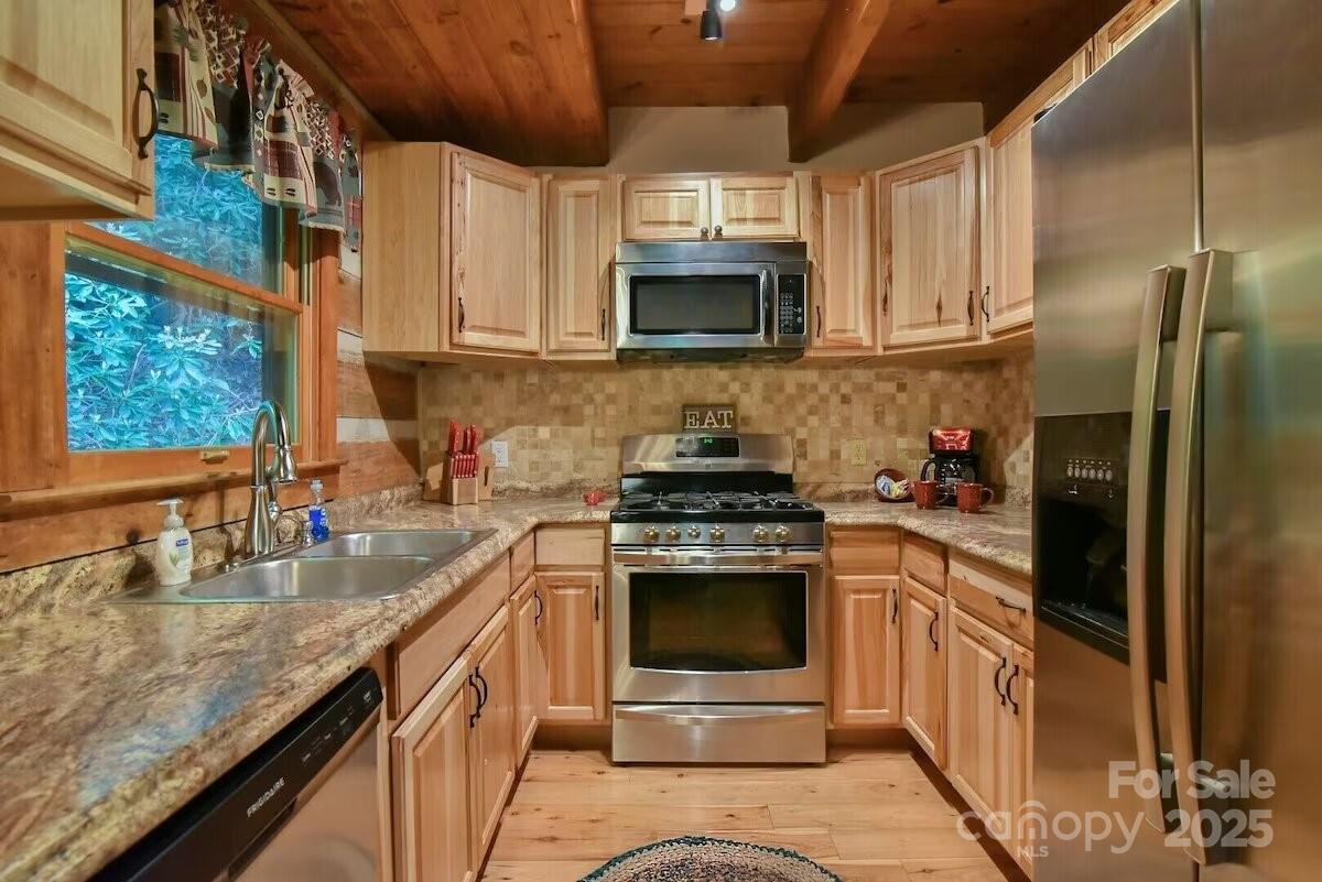 48 Buck Ridge Road Fairview, NC 28730 - Photo 10 of 38 a kitchen with stainless steel appliances granite countertop a stove a sink and a microwave
