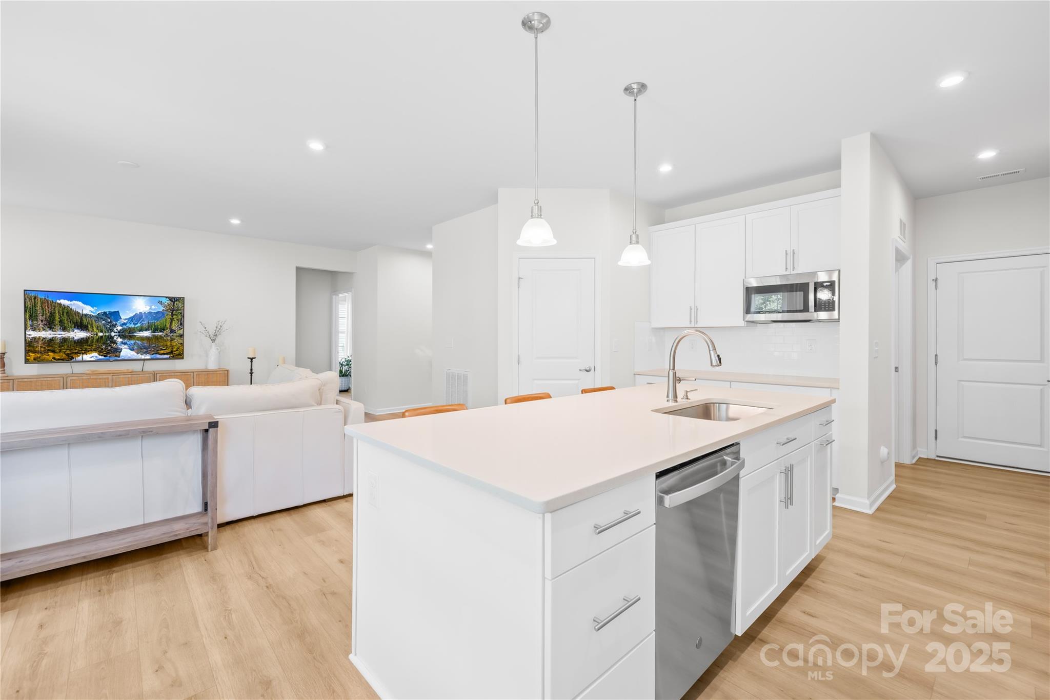 3110 Streamside Drive Davidson, NC 28036 - Photo 11 of 39 a large white kitchen with a sink a stove and a refrigerator