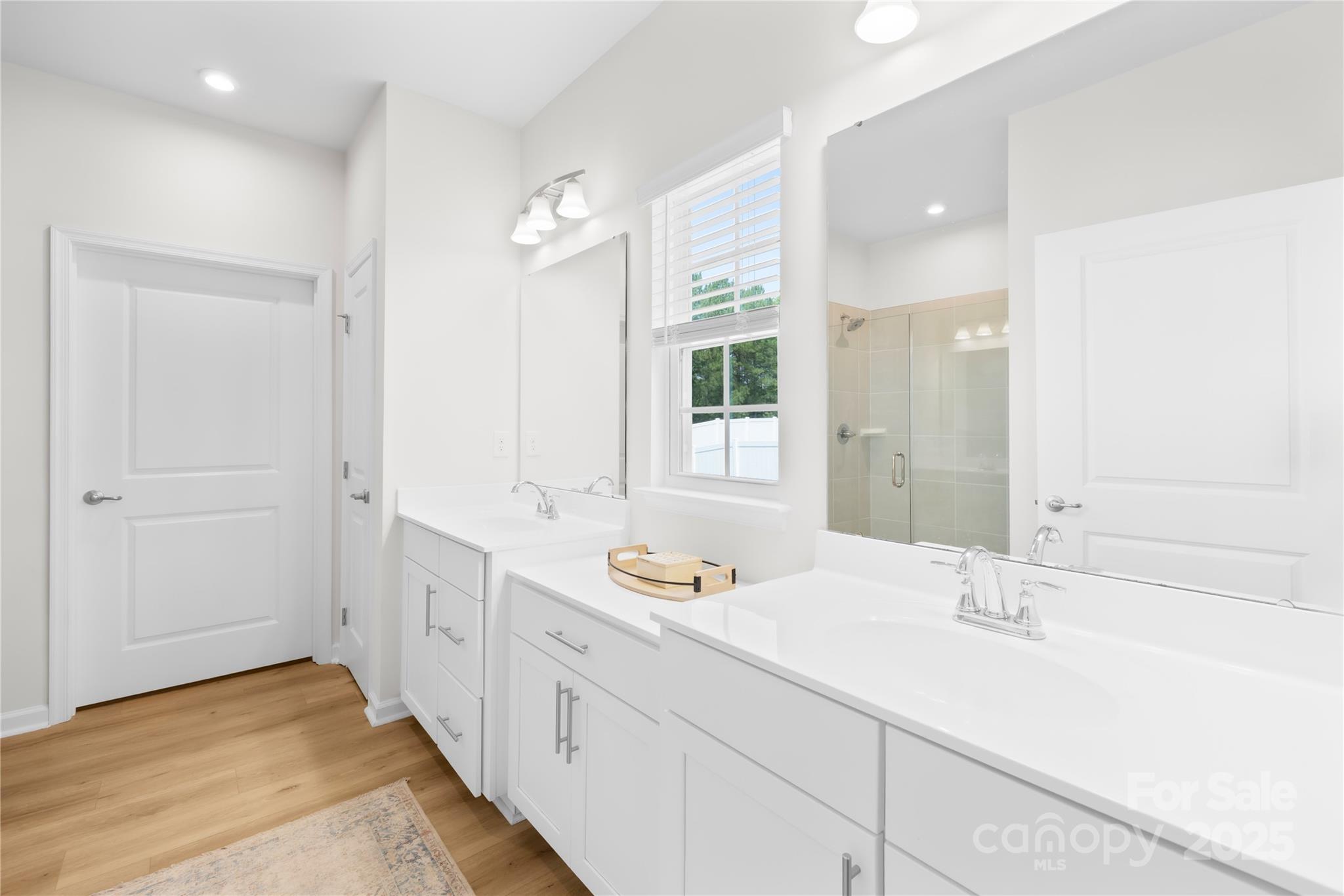 3110 Streamside Drive Davidson, NC 28036 - Photo 16 of 39 a bathroom with a sink double vanity and a mirror