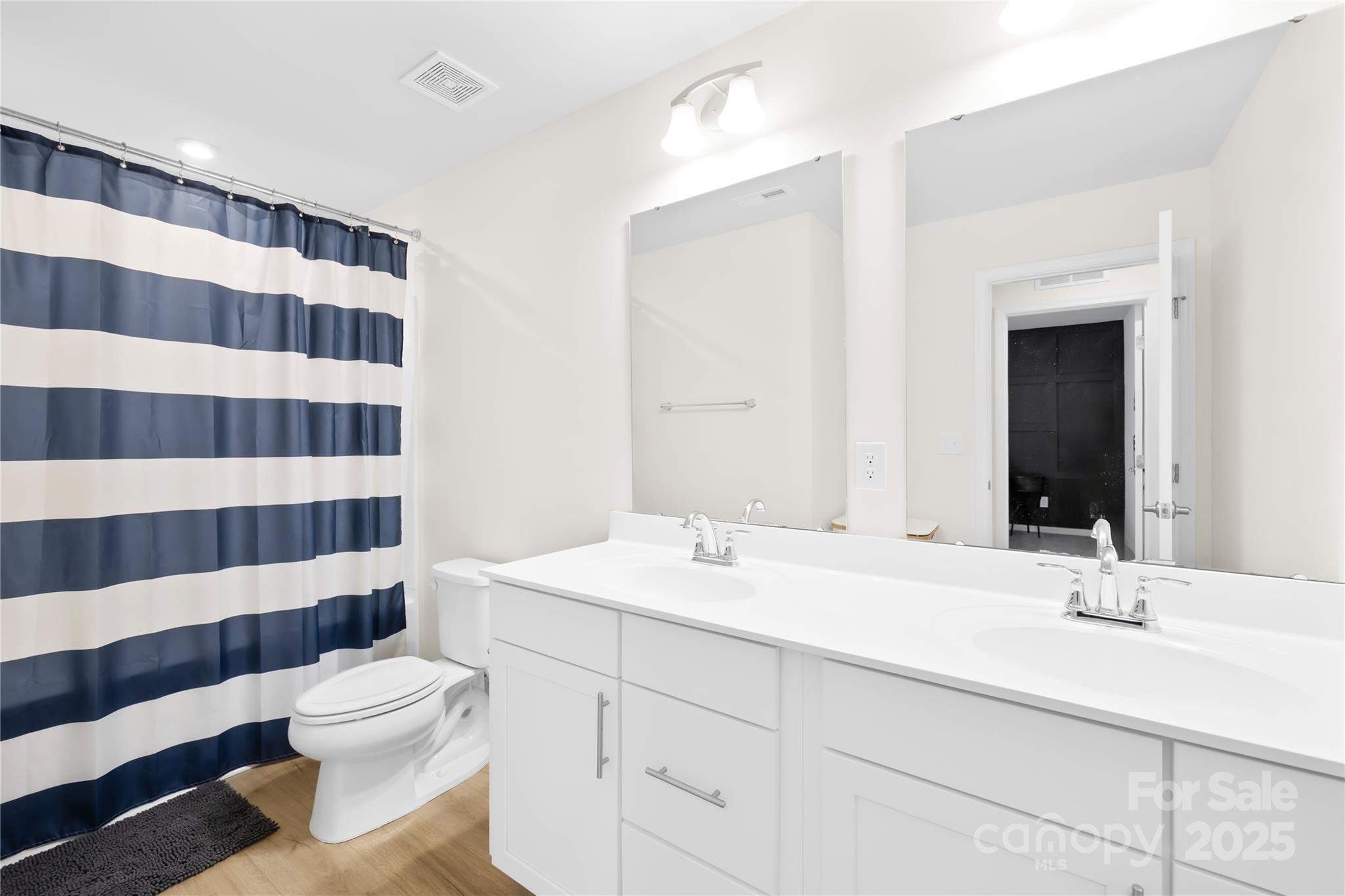 3110 Streamside Drive Davidson, NC 28036 - Photo 26 of 39 a bathroom with a sink a toilet a shower and a mirror